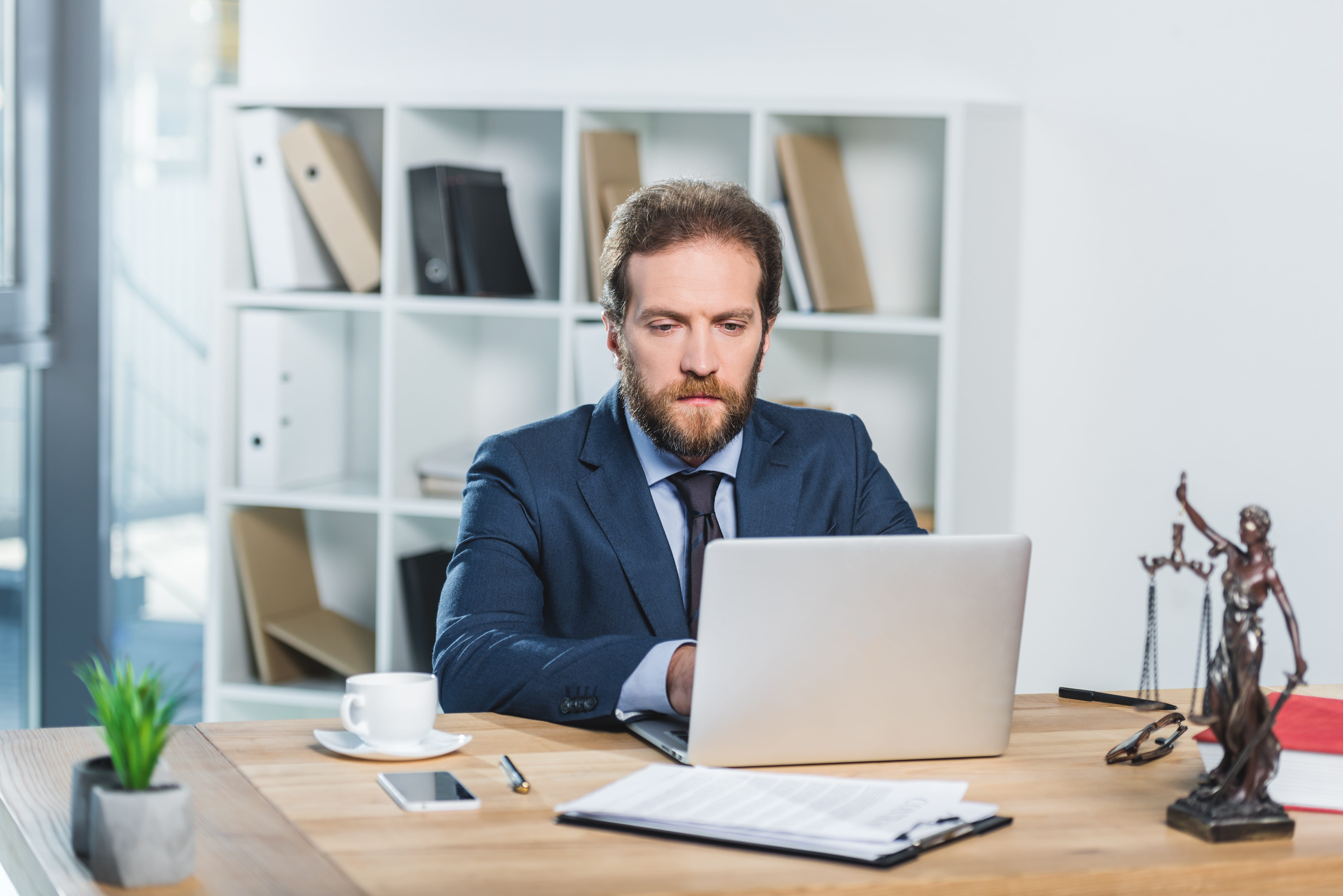 Man Working On Laptop At Workplace